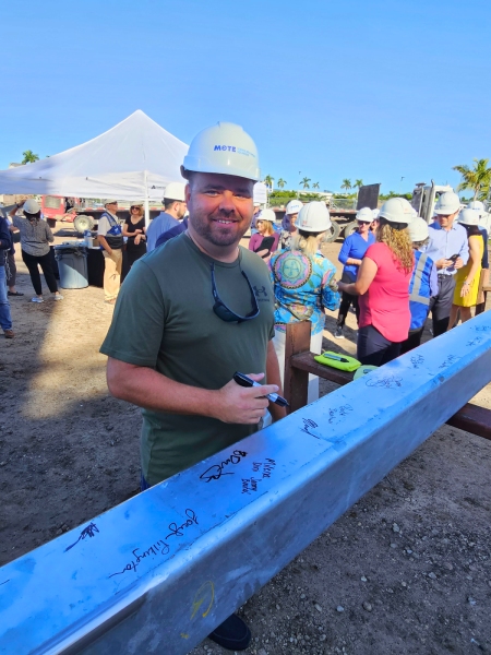 a98eeaa1-3990-4da5-a4f3-beb70051c019 Benderson Development team signing steel bar